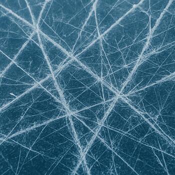 Close-up of white frost lines and fine cracks on a blue ice surface