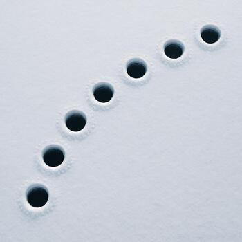 Overhead view of a gentle curved lane of small ice holes